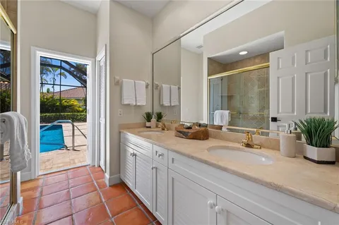 a spacious bathroom with a granite countertop sink mirror and bathtub
