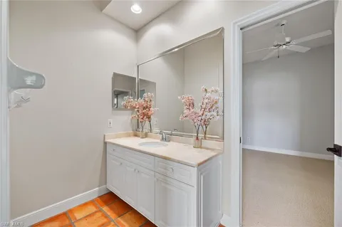 a bathroom with a sink vanity and a mirror