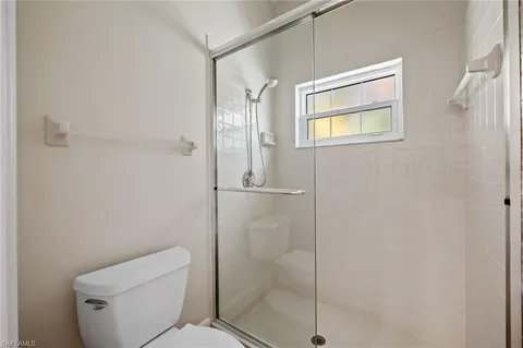 a bathroom with a shower a toilet and sink