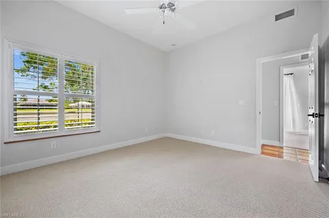 a view of a livingroom with an empty space and a window