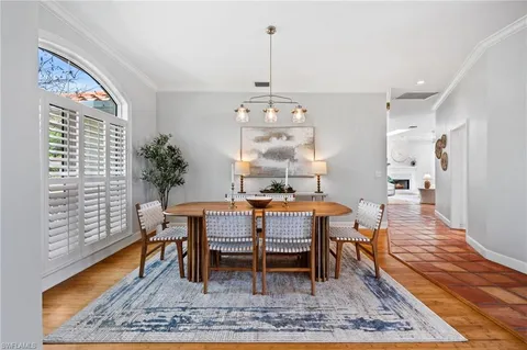 a dining room with a wooden table and chairs