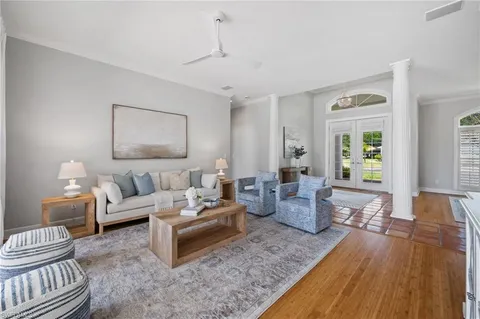 a living room with furniture and wooden floor