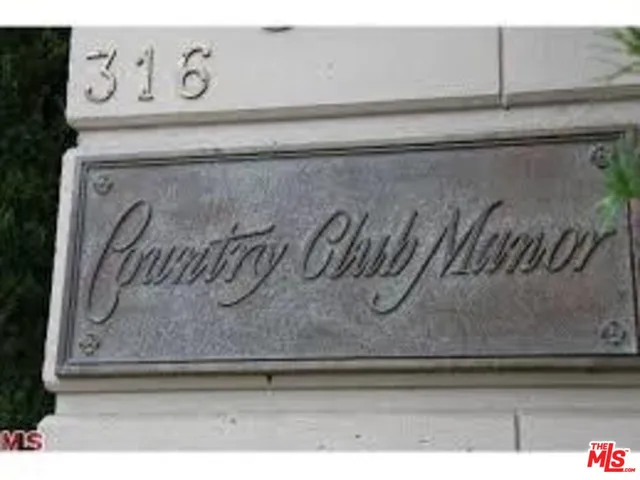 a front view of a residential apartment building with a yard