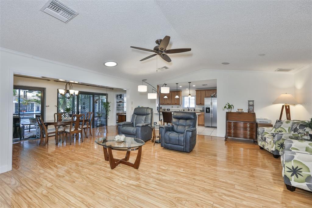 705 Baltusrol Way Sun City Center, FL 33573 - Photo 16 of 59 a living room with furniture and a wooden floor