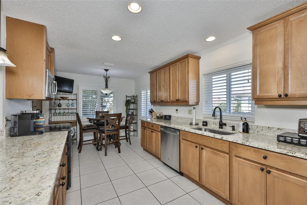 705 Baltusrol Way Sun City Center, FL 33573 - Photo 22 of 59 a kitchen with a sink a counter top space and appliances