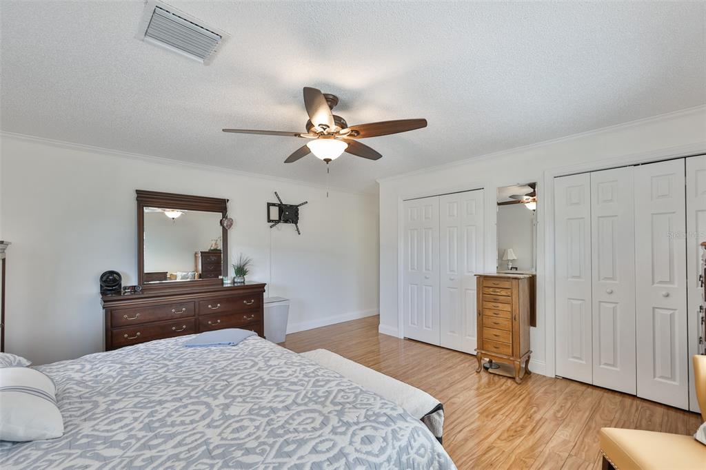 705 Baltusrol Way Sun City Center, FL 33573 - Photo 31 of 59 a bedroom with a bed and a dresser