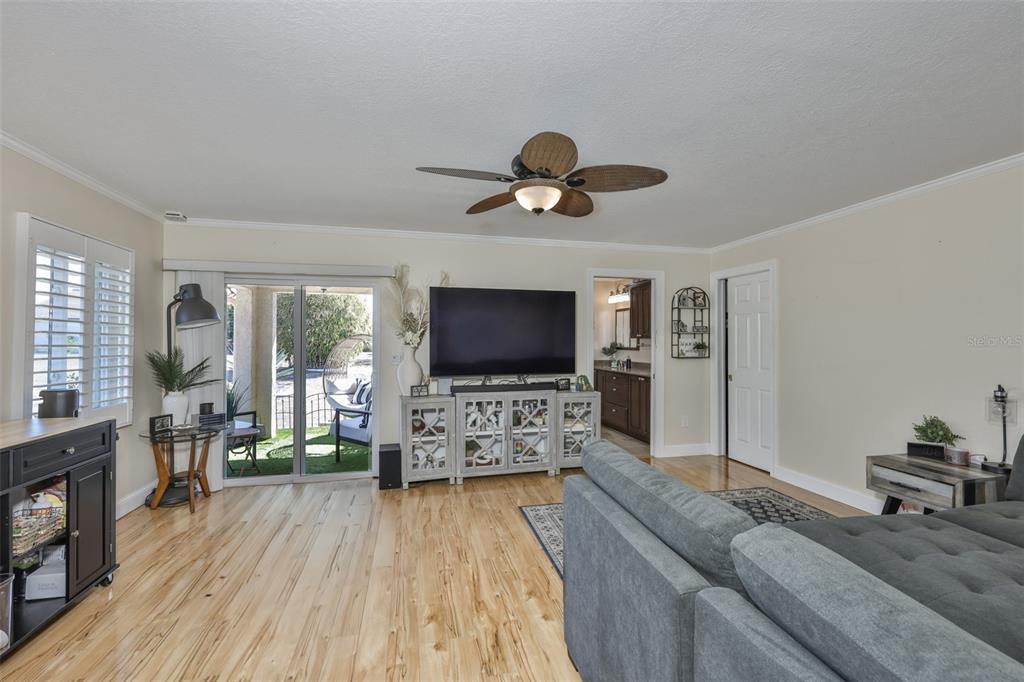 705 Baltusrol Way Sun City Center, FL 33573 - Photo 36 of 59 a living room with furniture and a flat screen tv
