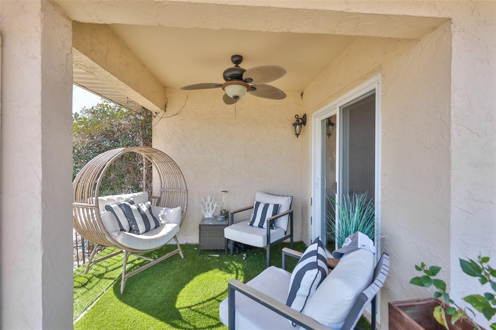 705 Baltusrol Way Sun City Center, FL 33573 - Photo 39 of 59 a living room with a couch and a chandelier