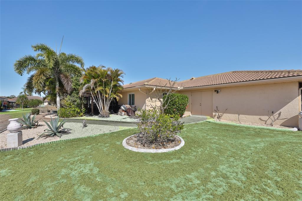 705 Baltusrol Way Sun City Center, FL 33573 - Photo 45 of 59 a view of a house with a swimming pool and a yard