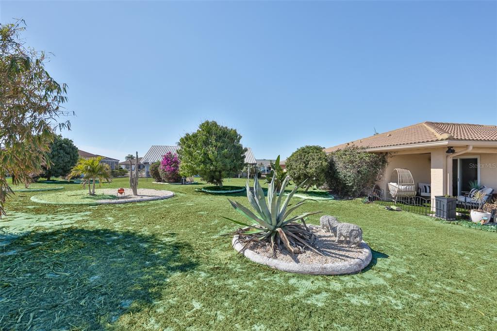 705 Baltusrol Way Sun City Center, FL 33573 - Photo 9 of 59 a view of a house with a backyard porch and sitting area