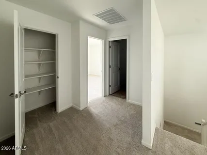 a view of an empty room with a closet