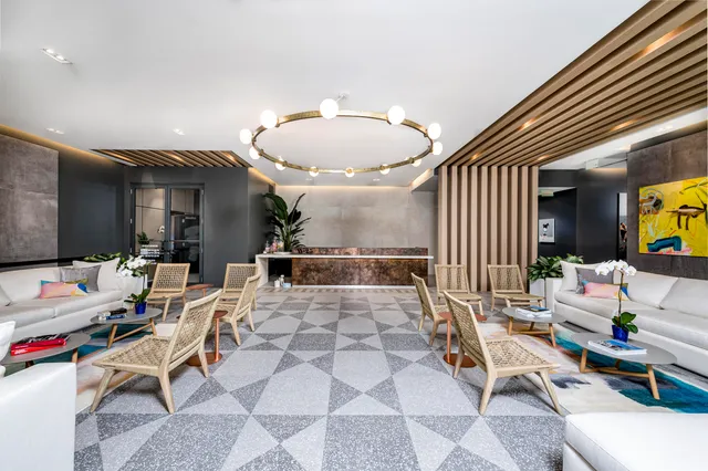 a living room with furniture a rug and a chandelier