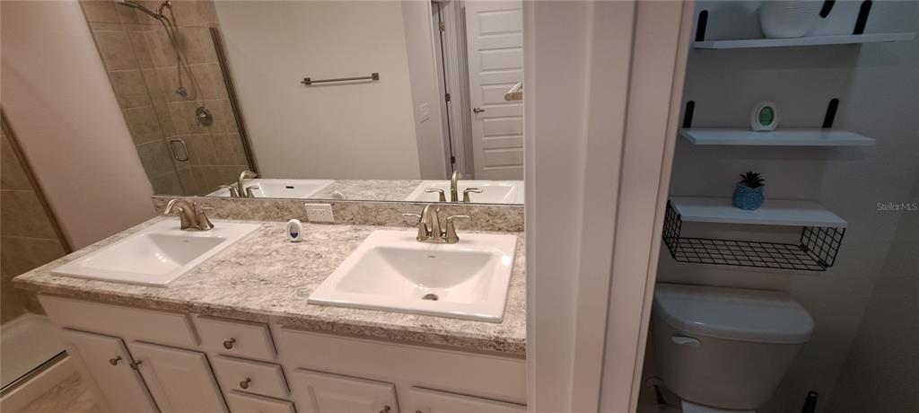 13052 Ogden Glade Road Dade City, FL 33525 - Photo 15 of 35 a bathroom with a sink and a toilet