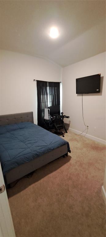 13052 Ogden Glade Road Dade City, FL 33525 - Photo 16 of 35 a bedroom with a bed and a night stand