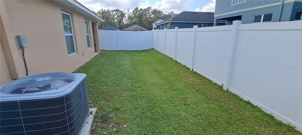 13052 Ogden Glade Road Dade City, FL 33525 - Photo 32 of 35 a backyard of a house with barbeque oven