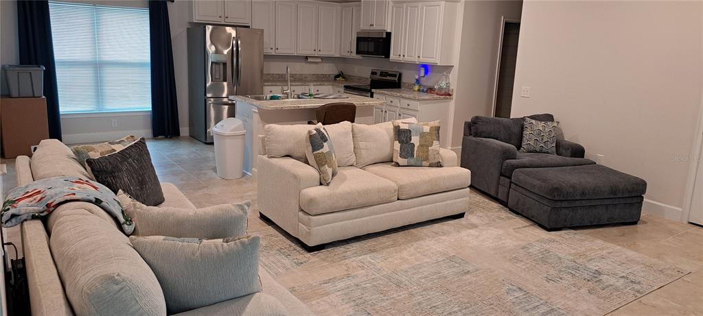 13052 Ogden Glade Road Dade City, FL 33525 - Photo 8 of 35 a living room with furniture and a large window