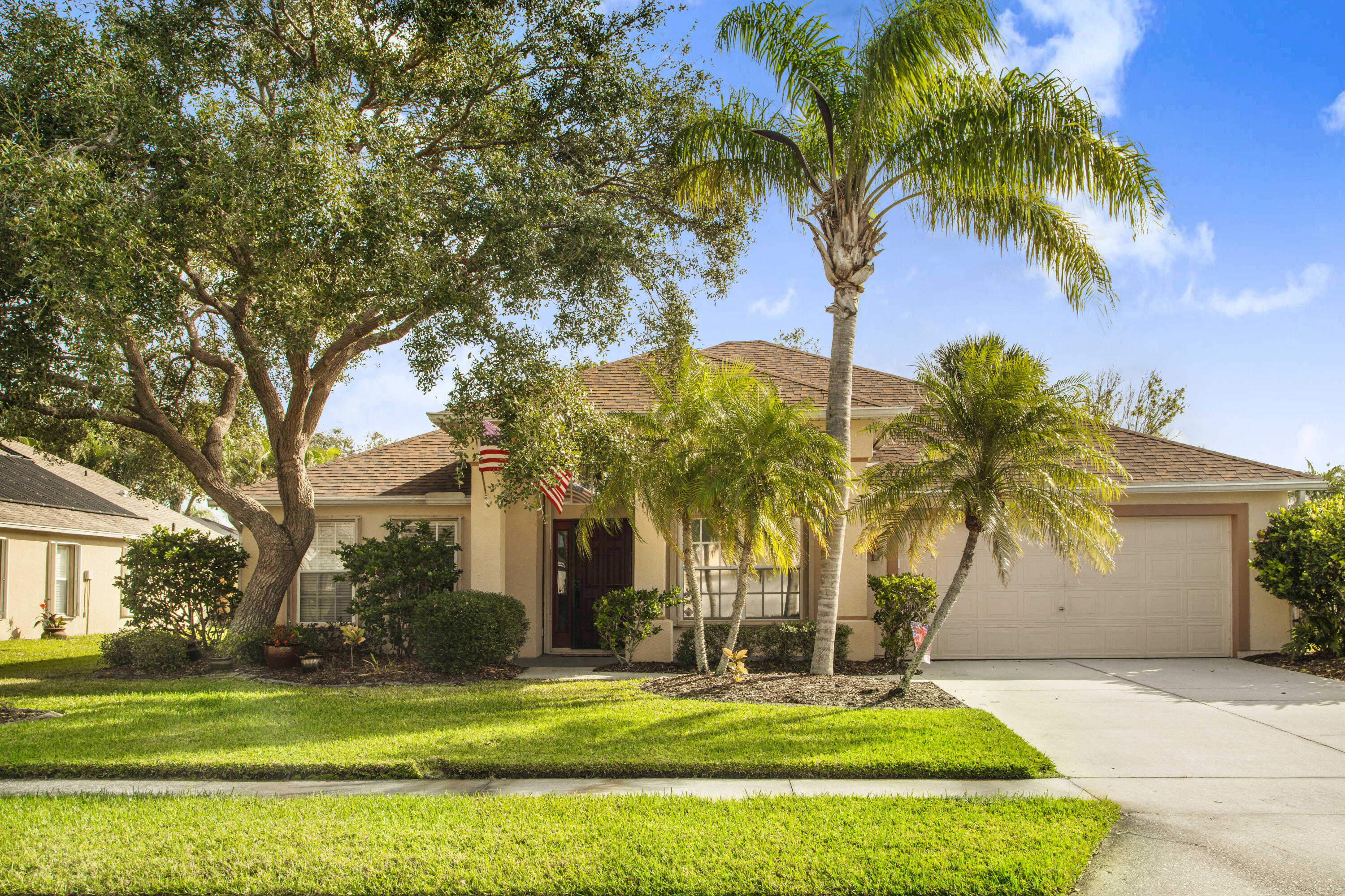 a house with palm tree in front of it
