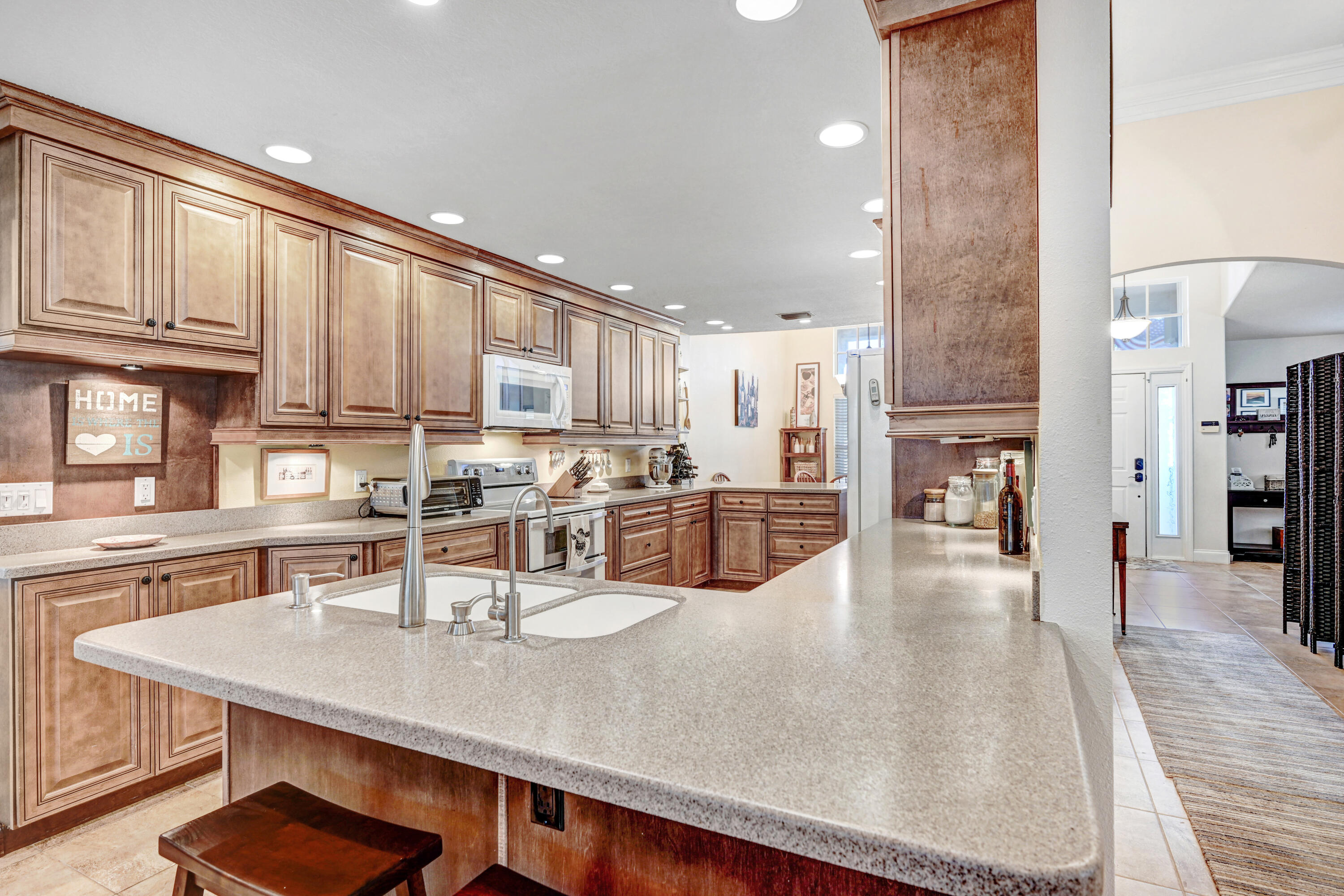 2795 Whistler Street Melbourne, FL 32904 - Photo 14 of 45 a kitchen with stainless steel appliances granite countertop a sink refrigerator and cabinets