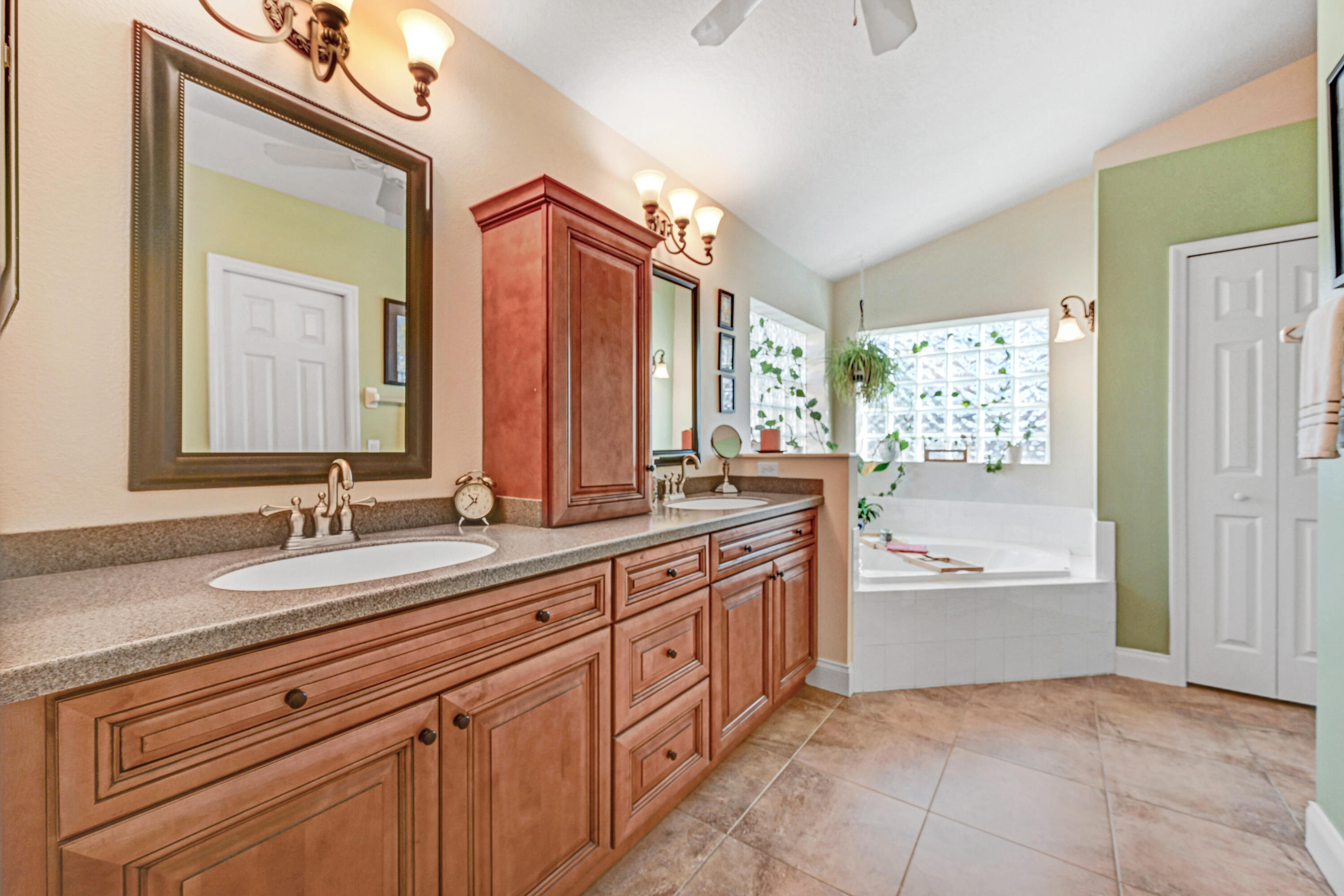 2795 Whistler Street Melbourne, FL 32904 - Photo 24 of 45 a bathroom with a granite countertop sink mirror and a bathtub