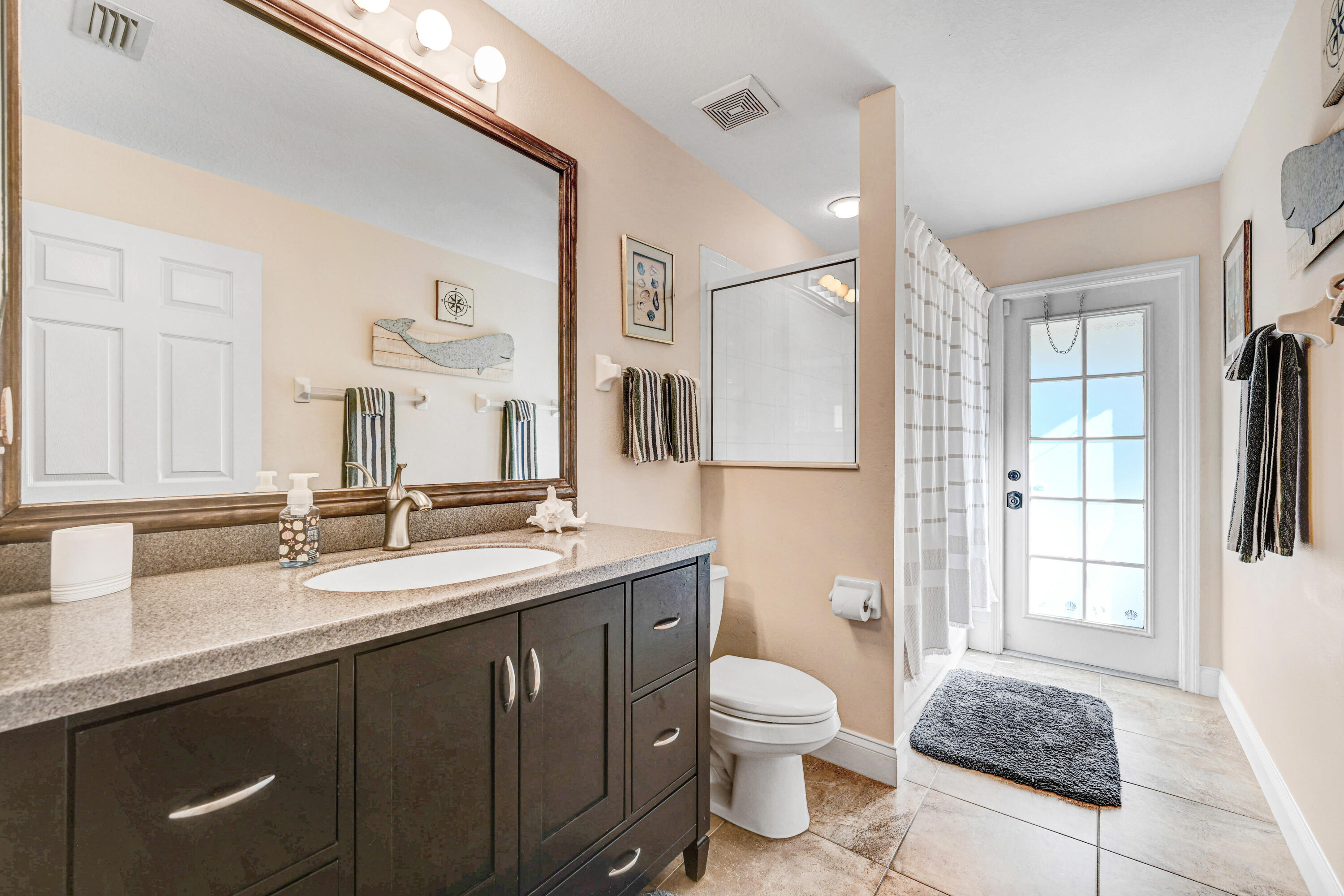 2795 Whistler Street Melbourne, FL 32904 - Photo 32 of 45 a bathroom with a sink a toilet and a mirror