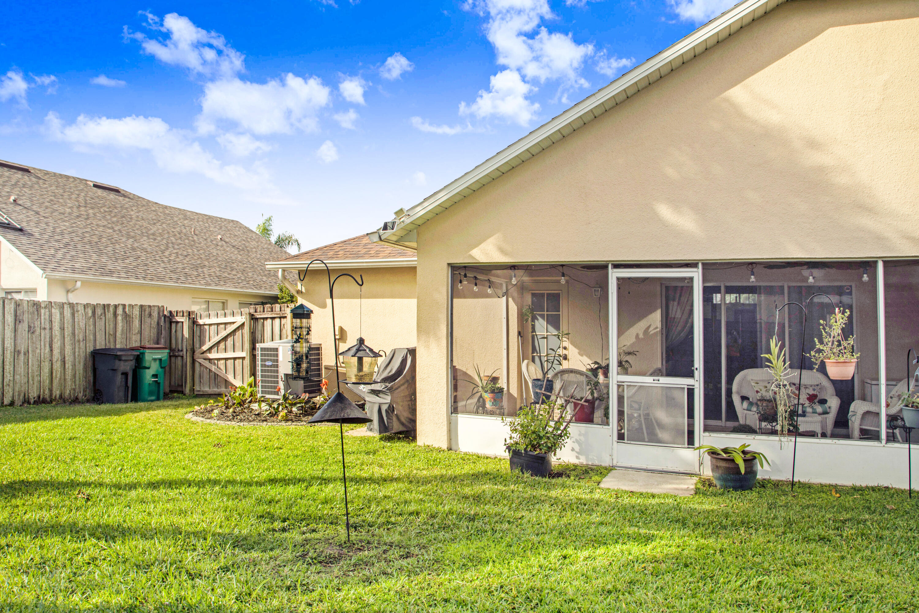 2795 Whistler Street Melbourne, FL 32904 - Photo 35 of 45 a view of a house with a big yard and potted plants