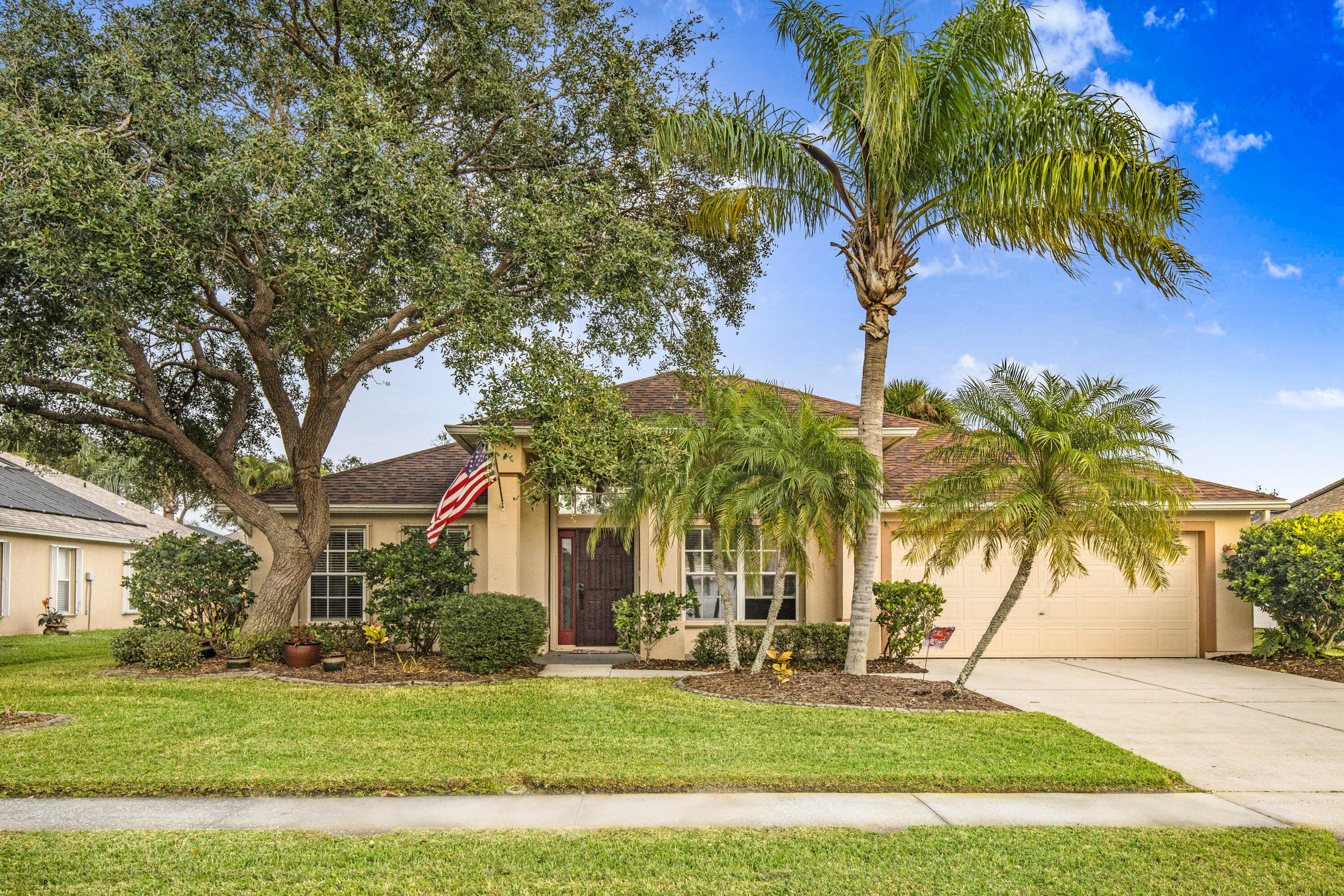 2795 Whistler Street Melbourne, FL 32904 - Photo 45 of 45 a view of a white house with a big yard and palm trees