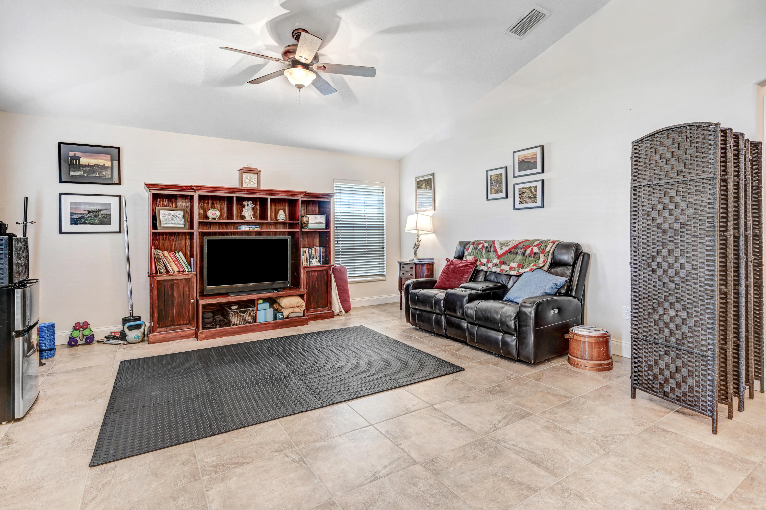 2795 Whistler Street Melbourne, FL 32904 - Photo 9 of 45 a living room with furniture and a flat screen tv