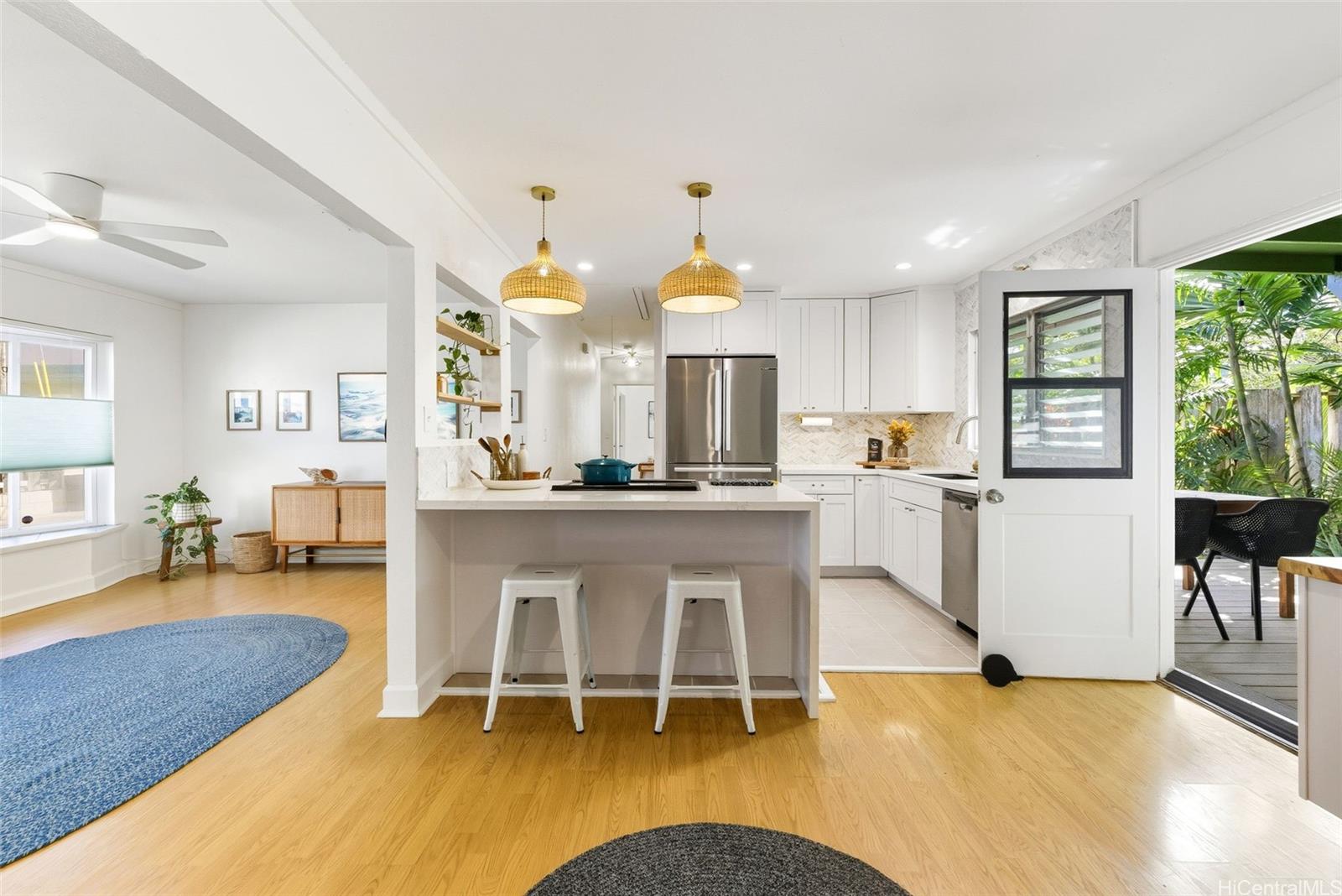 a living room with dining table and a large window