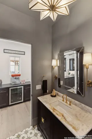 a bathroom with a granite countertop sink and a mirror