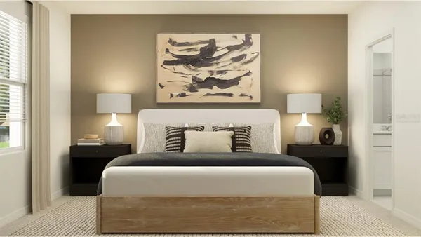 a bedroom with a bed and a lamp