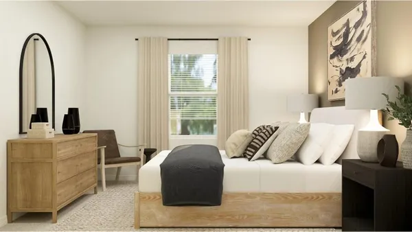 a bedroom with a bed and a large window