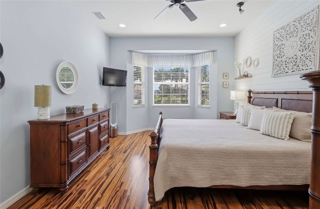 1771 Mistletoe Street Sebastian, FL 32958 - Photo 16 of 36 a bedroom with a bed and wooden floor
