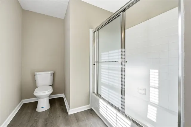 a bathroom with a toilet and a shower
