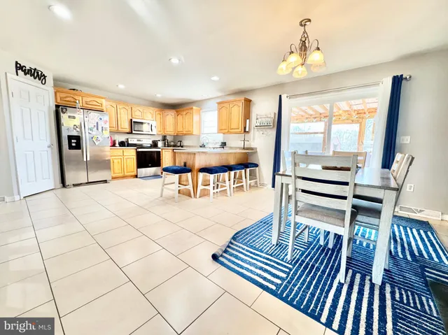 a living room with furniture a rug and white walls