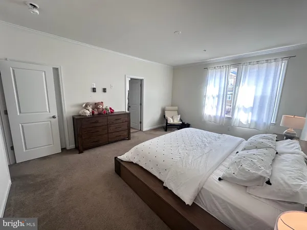 a spacious bedroom with a bed and window