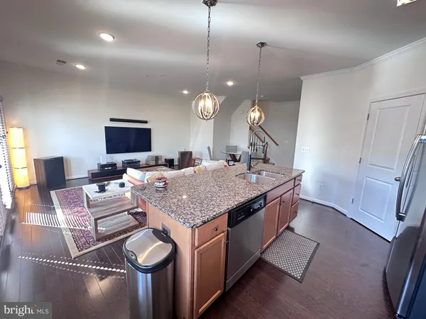 a living room with granite countertop furniture a fireplace and a flat screen tv