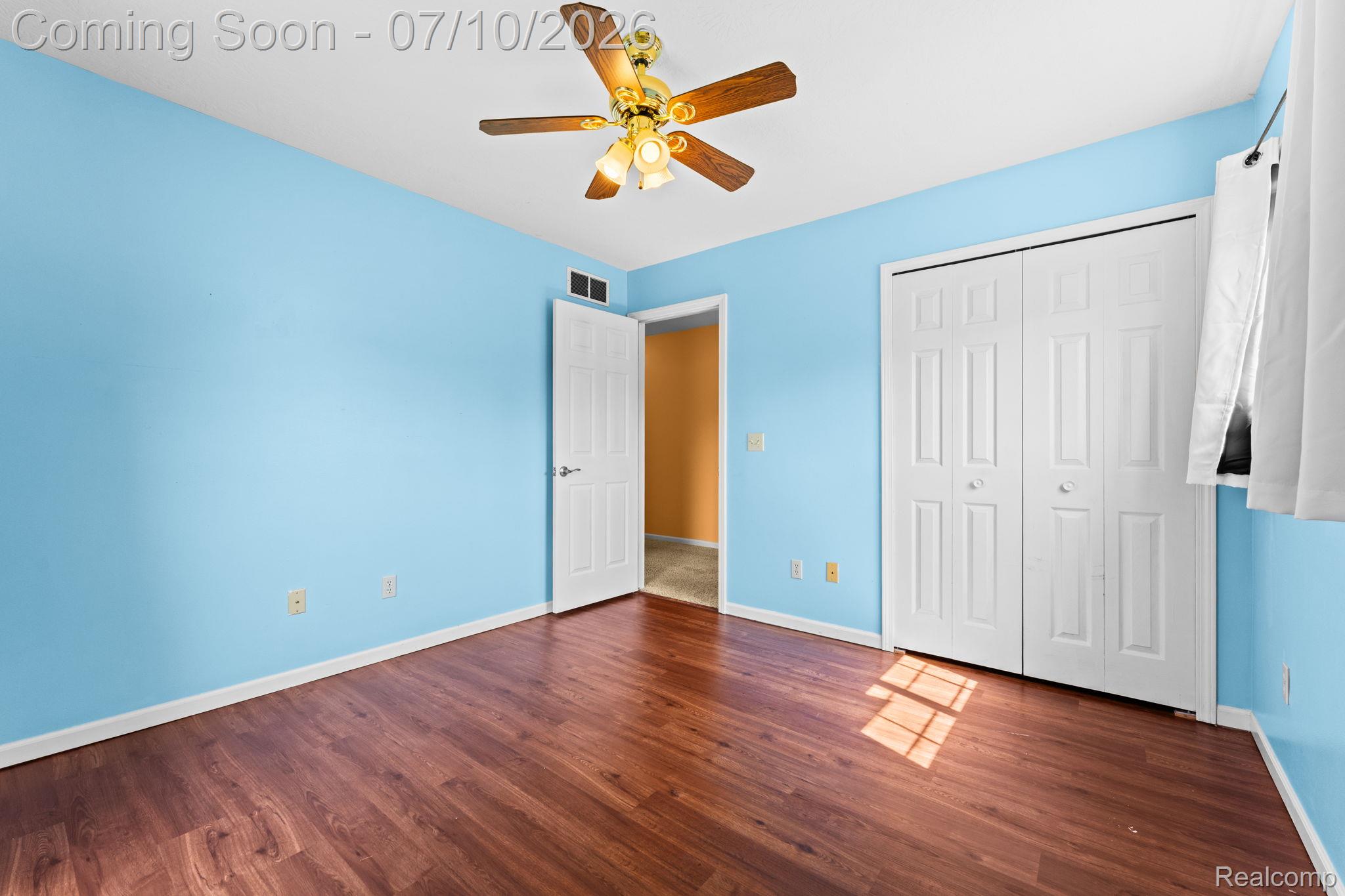 3144 North Nicholson Road Fowlerville, MI 48836 - Photo 49 of 70 Room with wood-finish flooring, light blue painted walls, and white trim