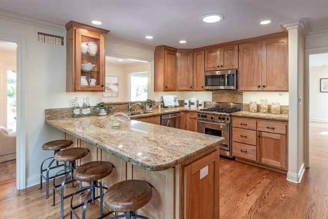 a kitchen with granite countertop a sink and stove