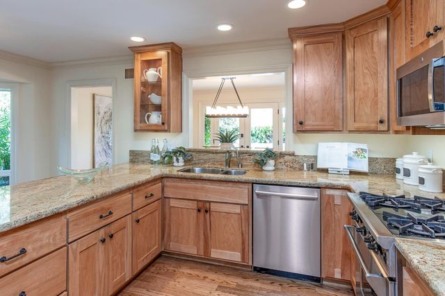 a kitchen with sink cabinets and stainless steel appliances