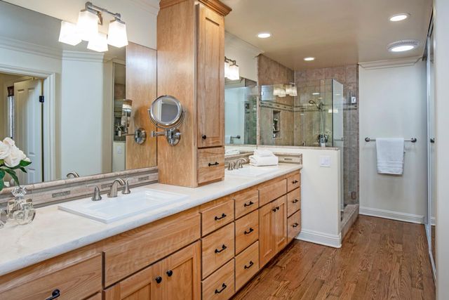 a bathroom with a granite countertop sink mirror and a shower