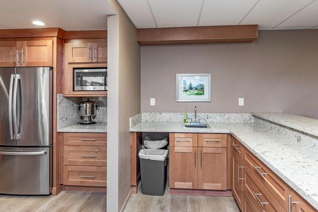 a kitchen with a refrigerator and a sink