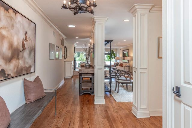 a dining room with furniture and wooden floor
