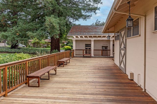 a view of a house with wooden deck