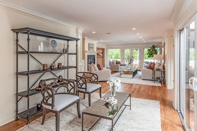 a living room with fireplace furniture and a large window