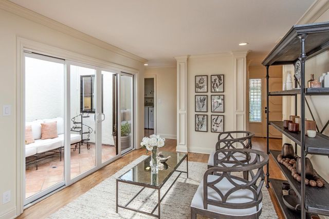 a living room with furniture and large windows