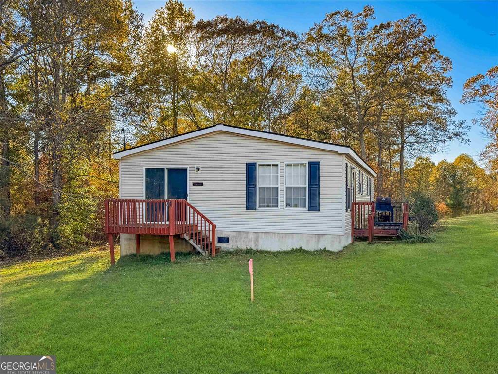 230 Surrett Road Buchanan, GA 30113 - Photo 2 of 17 a view of a house with a yard and sitting area