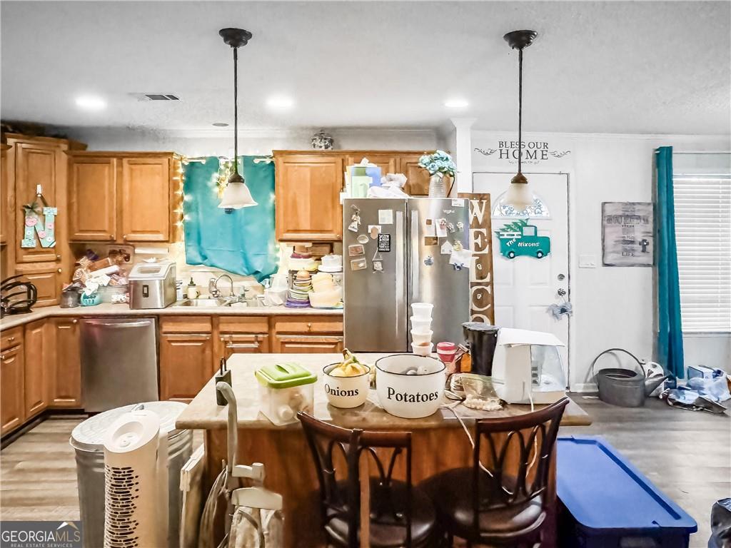 230 Surrett Road Buchanan, GA 30113 - Photo 5 of 17 a view of a dining room and livingroom with furniture wooden floor a chandelier
