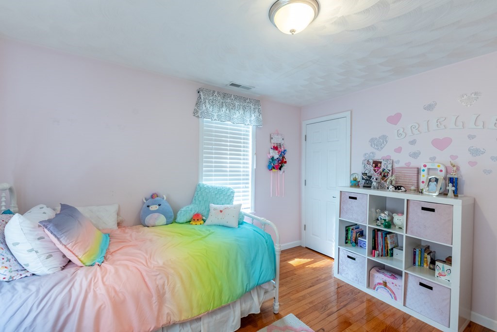 97 Bay State Road Methuen, MA 01844 - Photo 13 of 26 a bedroom with two beds and a book shelf