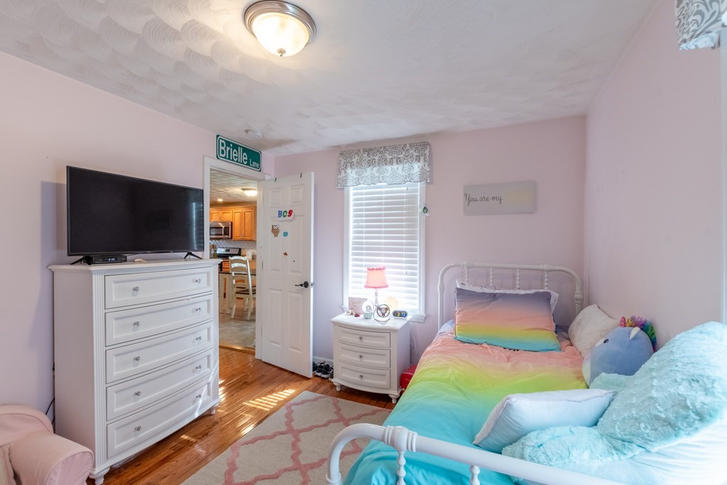 97 Bay State Road Methuen, MA 01844 - Photo 14 of 26 a bedroom with a bed and a flat screen tv