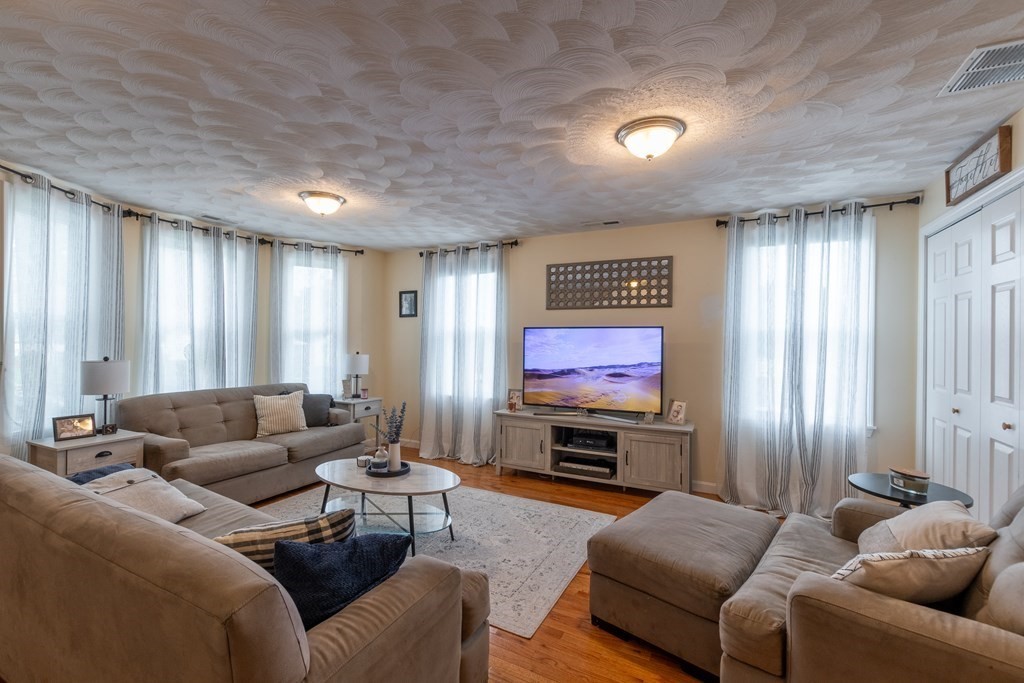 97 Bay State Road Methuen, MA 01844 - Photo 3 of 26 a living room with furniture and a flat screen tv